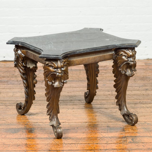 A bronze style side table from the mid-20th century with black marble top. Created with the traditional technique of the...