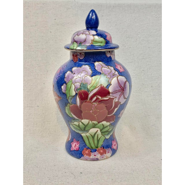 Vibrant vintage ginger jar. Blue background with multicolor floral design. Striking and perfect to add a pop of color to...
