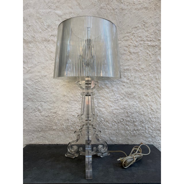 Tall clear acrylic lamp design by Ferruccio Laviani for Kartell, Italy. The manufacture’s mark is located on the base and...