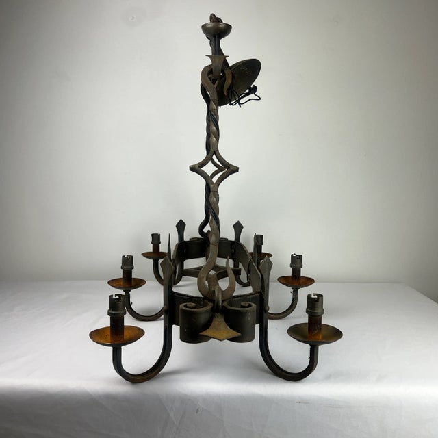 Lovely French oval wrought iron chandelier. The chandelier is really beautiful with Fleur de lis embellishments. It is...