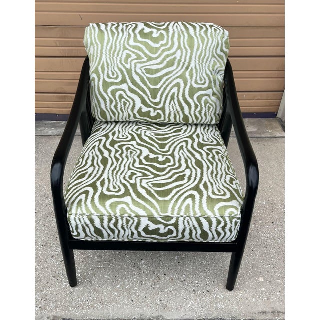 Pair of spindle back lounge chairs by Braxton Culler. The chairs have low backs transitioning gently into long arms and...