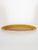 An elegant oval glazed ceramic serving platter featuring a warm gradient of browns and ochre—characteristic of French...