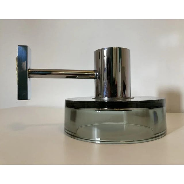 Sconce designed by Flavio Poli for Seguso in the 1960s. This wall lamp, with chromed metal structure, has a glass...