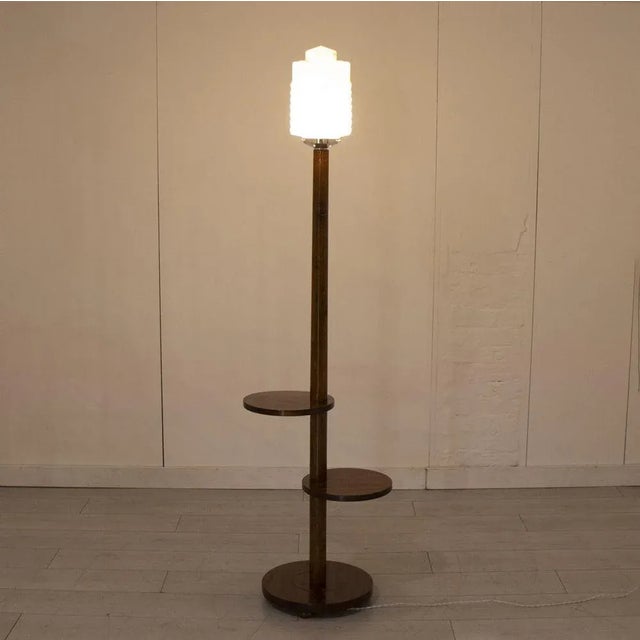H: 180.5cm w: 49cm d: 38cm an art deco floor lamp with original caramel-coloured marbled glass shade in a skyscraper...