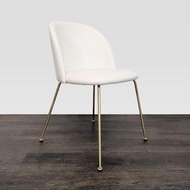 This mid-century modern dining chair blends upholstered curves with sleek industrial legs. It has an ergonomic design for...