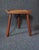 Mid century modern stool , made of walnut , half round top with dished seat , 3 legs mortised thru the top