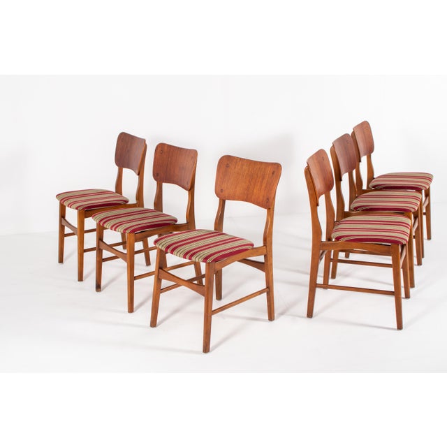 A beautiful set of six Danish dining chairs designed by Ib Kofod-Larsen, dating from the 1960s. These elegant chairs...