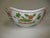 A hand-painted Andre by Sadek porcelain bowl. It has a scalloped shaped rim with gold trim. The sides both inside and...