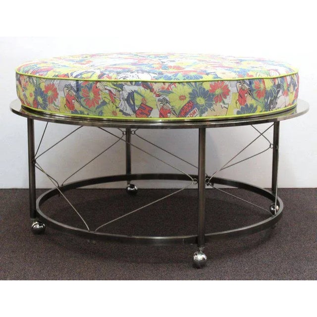 Mid century ottoman with chrome frame on castors and new upholstery. Features include a circular frame with wire trestles...