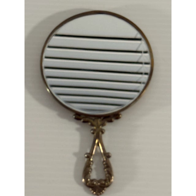This exquisite vintage hand mirror is crafted from 800 silver and features a beautiful intricate engine-turned pattern...