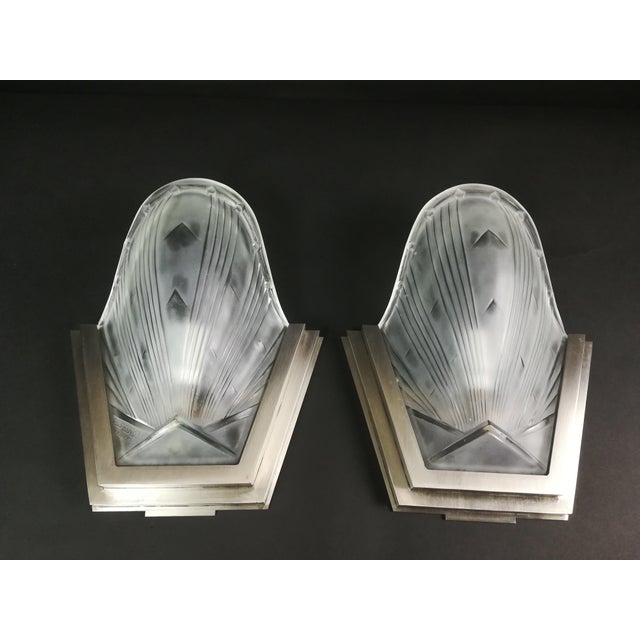 Silver-plated bronze, with satinised pressed glass, one signed. The luminaire has been rewired according to current safety...