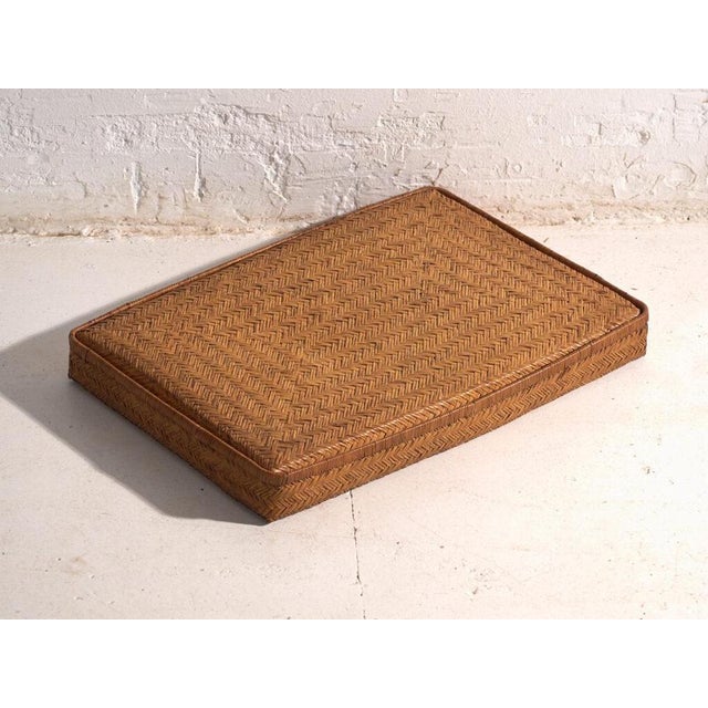 This set of two antique japanese flat cases is composed by two woven-rattan containers with a low profile, a full lid and...