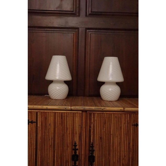 Beautiful pair of glass lamps from Murano. Italian design. Twisted decoration. Excellent condition for each of them....