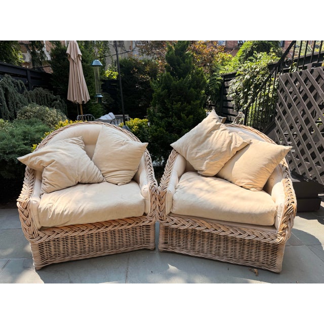 This elegant pair of vintage braided rattan lounge chairs exemplifies the effortless charm and relaxed sophistication of...