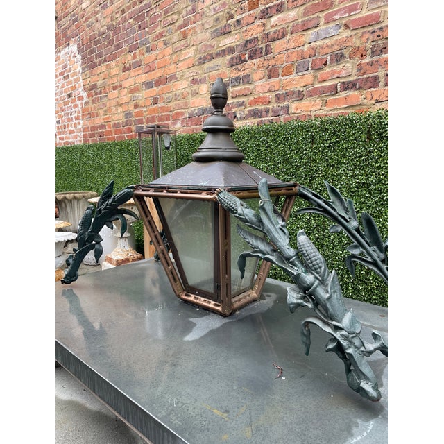 Large Cast Iron and Copper Entryway Gas Lantern, 20th c., with a turned finial top over tapered glass sides, on double...