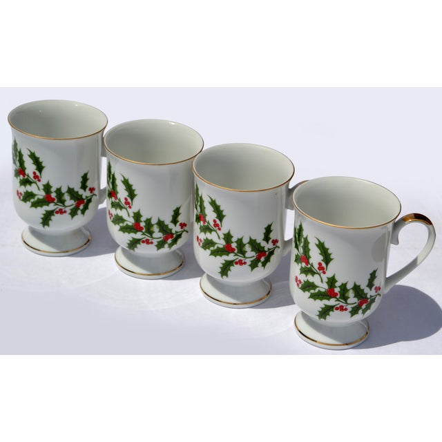 The Set of 4 Christmas Holly Footed Mug by All the Trimmings is a vintage porcelain mug featuring a festive holly design,...