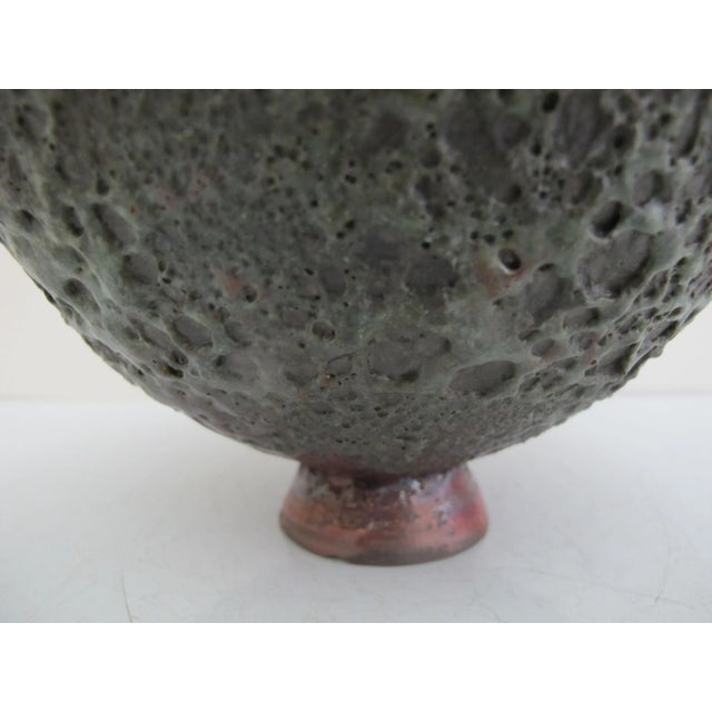 Beatrice Wood (Beato) earthenware pottery bowl. Heavily textured, deeply porous 'volcanic' pottery with in mostly red...
