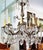 Impressive Bronze and crystal chandelier, mid-century era, 12 lighbulbs refract through 3 levels of 106 crystals including...