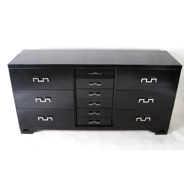 Presented here is a mid century black lacquered credenza dresser with unique geometric chrome handles. With its clean...