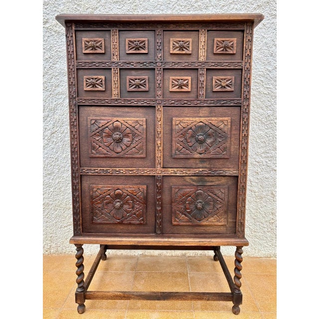 Beautiful early 20th-century Spanish hand-carved oak cabinet, crafted around 1900–1920 in a Renaissance style. The façade...