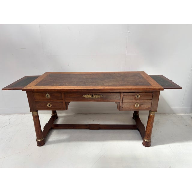 Empire style desk in mahogany and mahogany veneer four column legs with h-shaped stretchers three drawers in the front...