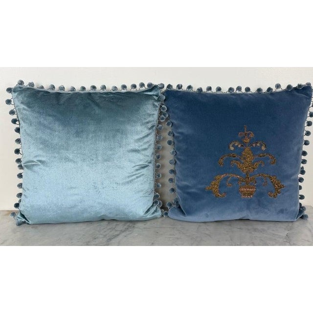 An extraordinary pair of couture pillows centered around a true piece of history. Each pillow is crafted from a sumptuous...