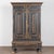 Late 18th century Swedish two-door armoire crafted in oak. The upper section is crowned with a carved putti face and wings...