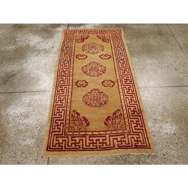 A vintage Chinese Art Deco throw rug handmade during the Mid-20th century. Measures: 2' 9" x 5' 8"