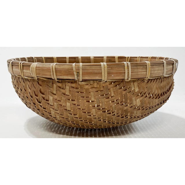 Vintage winnowing basket with substantial bamboo rim and tight basket weave. Makes an amazing coffee table catchall! Minor...