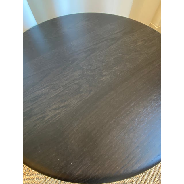 Elevate your living space with this striking, low-profile cocktail table. Crafted with a sleek, circular tabletop and a...