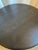 Elevate your living space with this striking, low-profile cocktail table. Crafted with a sleek, circular tabletop and a...