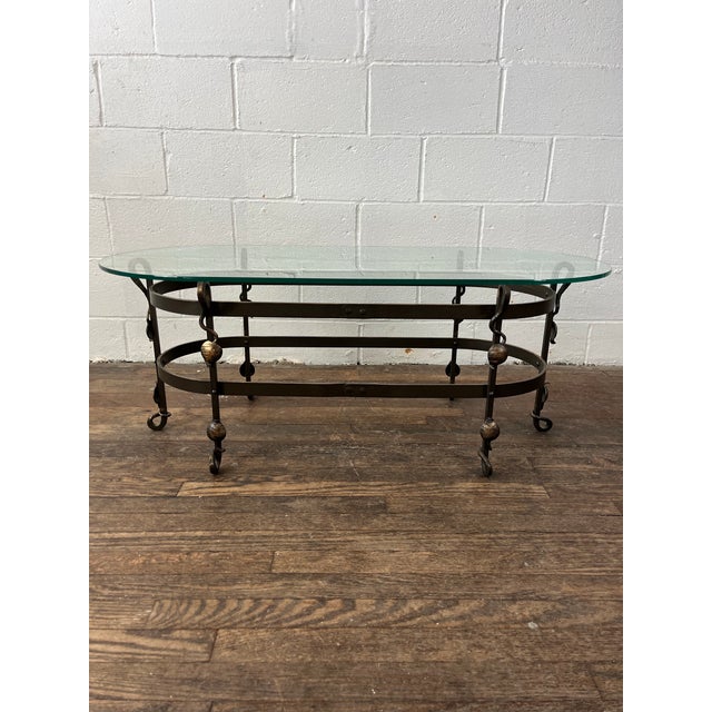 Early 20th Century Arts & Crafts oval coffee table. Original double oval ringed iron base with 6 scrollwork legs with...