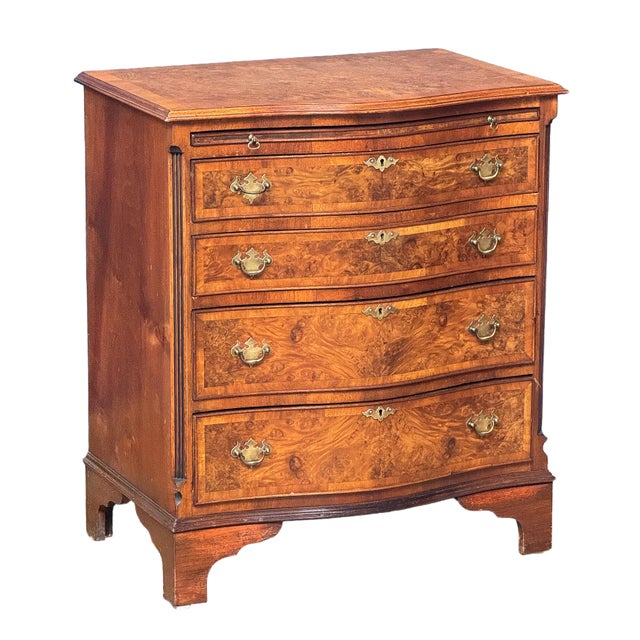 A fine English bachelor's small chest of drawers (or side chest) from the Edwardian era, featuring a moulded, shaped top...