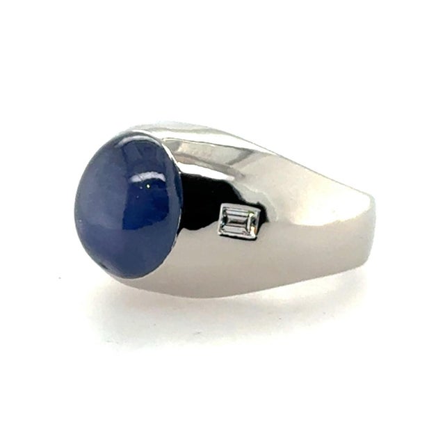 Platinum ring with 14.34 carat blue star sapphire and two baguette diamonds weighing 0.14 carats. 24.74g