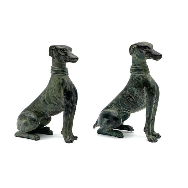 An exquisite pair of French Art Deco sculptures depicting two greyhounds in elegant poses. The figures embody the "purity...