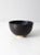 This is a vintage studio pottery bowl. Signed by the artist, the handmade ceramic bowl has a black exterior with striking...