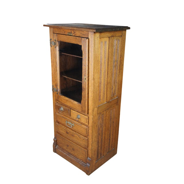 Early 20th Century Harvard Company Dental Cabinet. A petite showcase made from quartersawn oak with two interior shelves...
