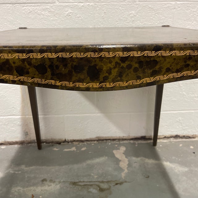 An antique olive green and black faux tortoise leather card table with gold tooled designs on the top and sides. This...
