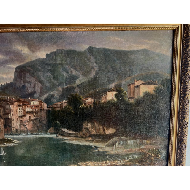 Oil on canvas "Lively Village by the River" Depicts a village against a mountain backdrop Lively scene with a woman...