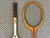 A pair of beautiful midcentury vintage wooden tennis rackets with leather grips. Classic Spalding and Slazenger brands....