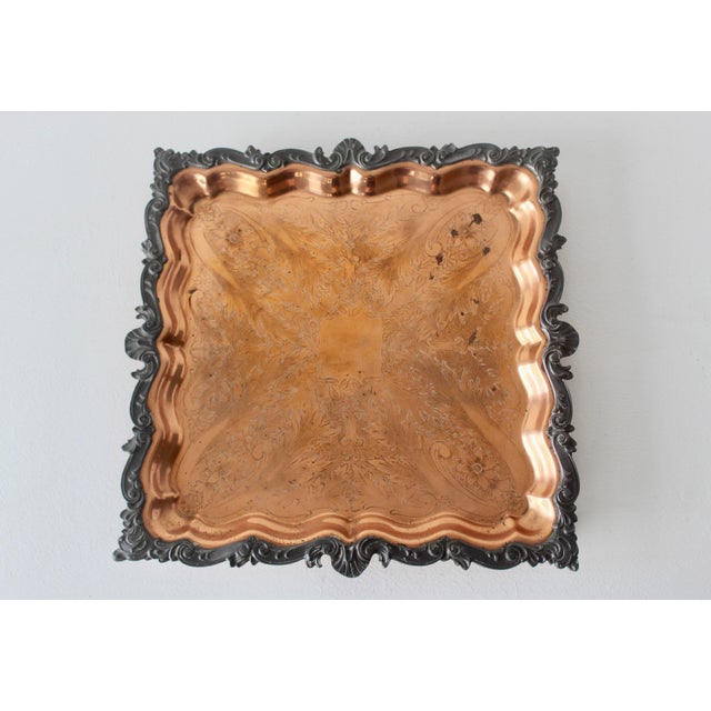 Vintage English pewter and copper serving tray. Copper base, featuring an ornate, scalloped border with floral and scroll...