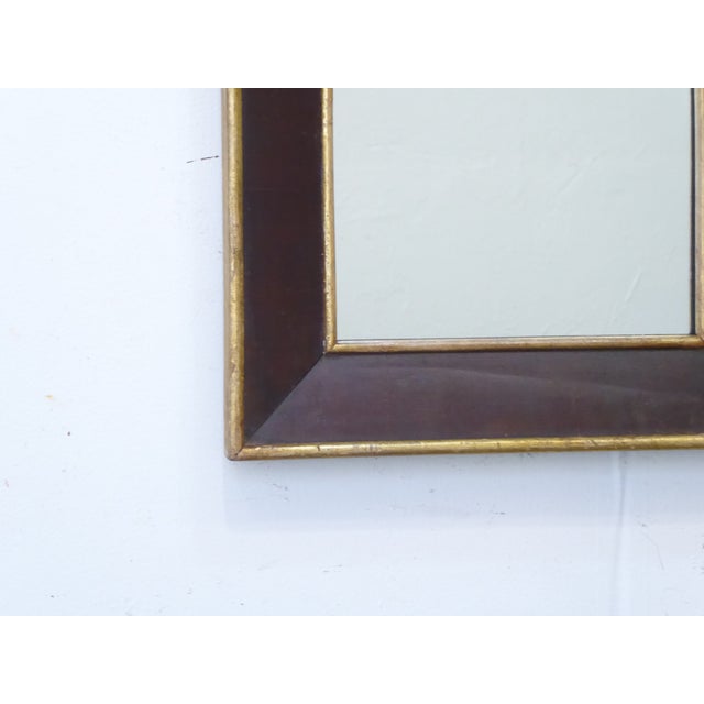 This mahogany mirror has a giltwood liner and outside trim and measures 31.25"H x 16"W.
