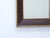This mahogany mirror has a giltwood liner and outside trim and measures 31.25"H x 16"W.