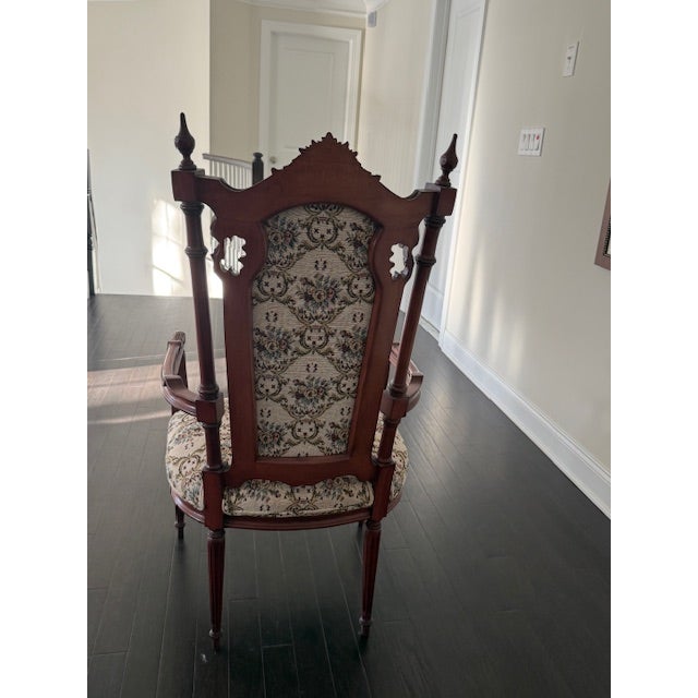 This antique carved wood armchair is a beautifully detailed accent piece with classic proportions and a traditional...