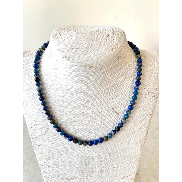 Lovely lapis beaded necklace with gold tone adjustable clasp. Design designed by Matthew Izzo.