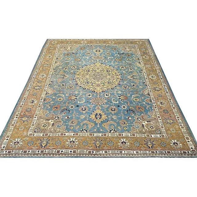 ACTUAL SIZE: 9’3″ x 12’7″ PRIMARY COLOR: Blue / Gold AGE: Old MATERIALS: Wool FOUNDATION: Cotton PRODUCTION: Handwoven,...