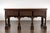 An English oak sideboard from the 19th century with three low-relief carved drawers, carved legs and brass hardware....