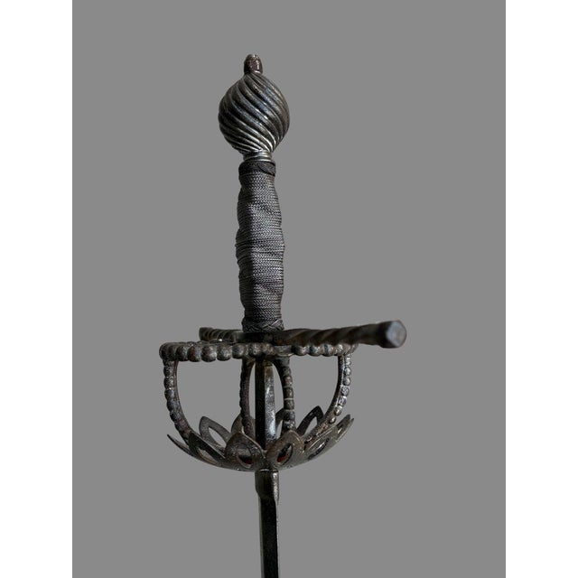 17th century shell-shaped rapier with a tazaIron hilt, shell guard pierced with a floral motif, filigreed iron gripThe...