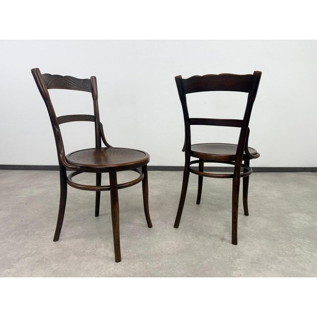 Set of 2 dining chairs by J&J Kohn in excellent vintage condition with signs of use.