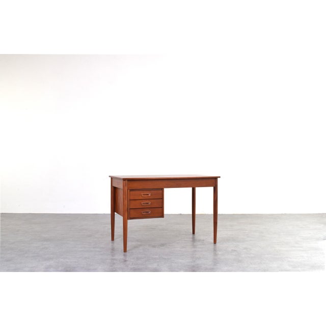 A classic Danish teak desk, crafted in the 1960s, is a perfect example of mid-century modern design. The design combines...